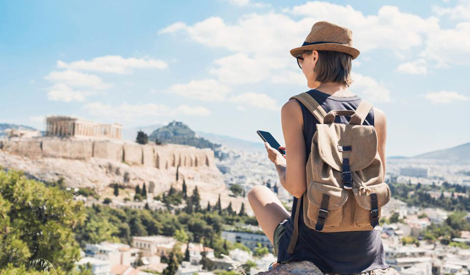 person-overlooking-village-while-travelling